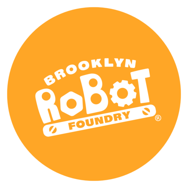 This is an orange circle with a white border. Inside the circle is the Brooklyn Robot Foundry logo in white.