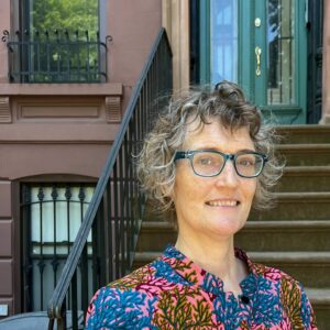 Picture of Caroline Crilly in front of her stoop in Bed-Stuy