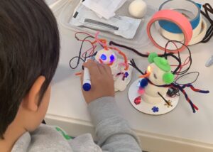 Photo of student building snowbot robots