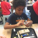 Photo of student building a robot