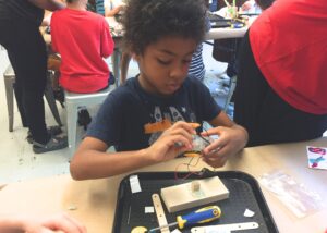 Photo of student building a robot