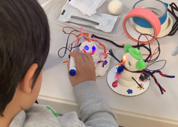 Photo of student building snowbot robots