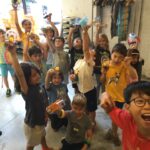 A large group of silly children holding up their robots