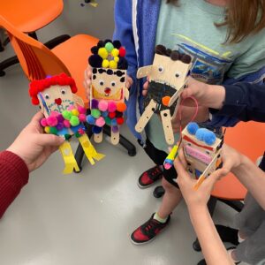 Photo of 4 kid-made robots being held in their hands