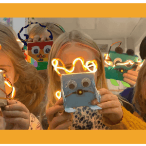 image of kids holding their light up robots