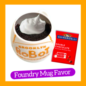 Photograph of Brooklyn Robot Foundry mug with chocolate cake and dollop of whipped cream inside. On the right is a red package of Ghiradelli Double Chocolate mug cake mix. On the bottom is a purple pill-shaped bar with "Foundry Mug Favor" in white letters inside. An orange square frame surrounds it all.