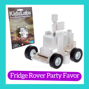 Photograph of Zero Gravity Friday Rover from Kidz Labs. On the left is a picture of the toy in its packaging. On the bottom is a purple pill shaped bar with white lettering "Fridge Rover Party Favor". A turquoise square outline frames all of it.
