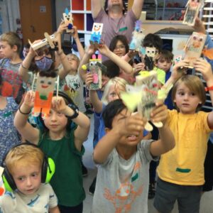 Photo of many students holding up their robots