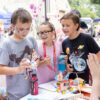 Three kids exploring hands-on robotics