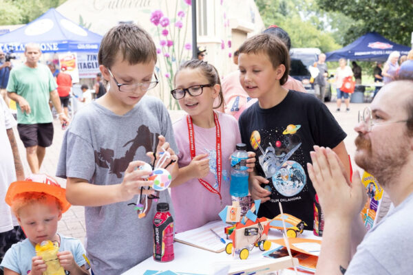 Three kids exploring hands-on robotics