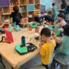 Children building robots at a table