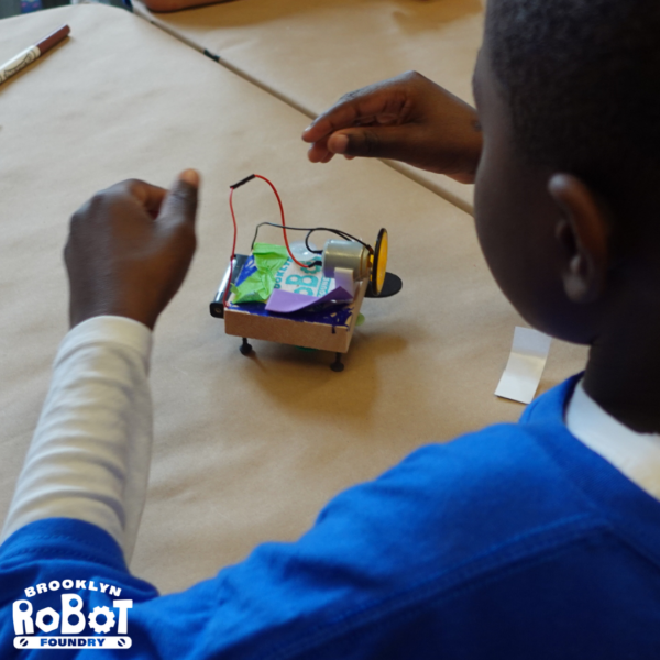 Young boy playing with robot