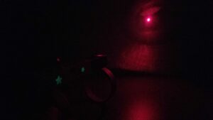 Laser Limb Robot in use, dark background with laser shinning