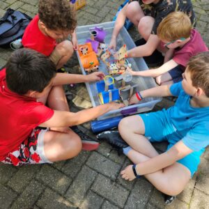 Kids playing outside with boat robot