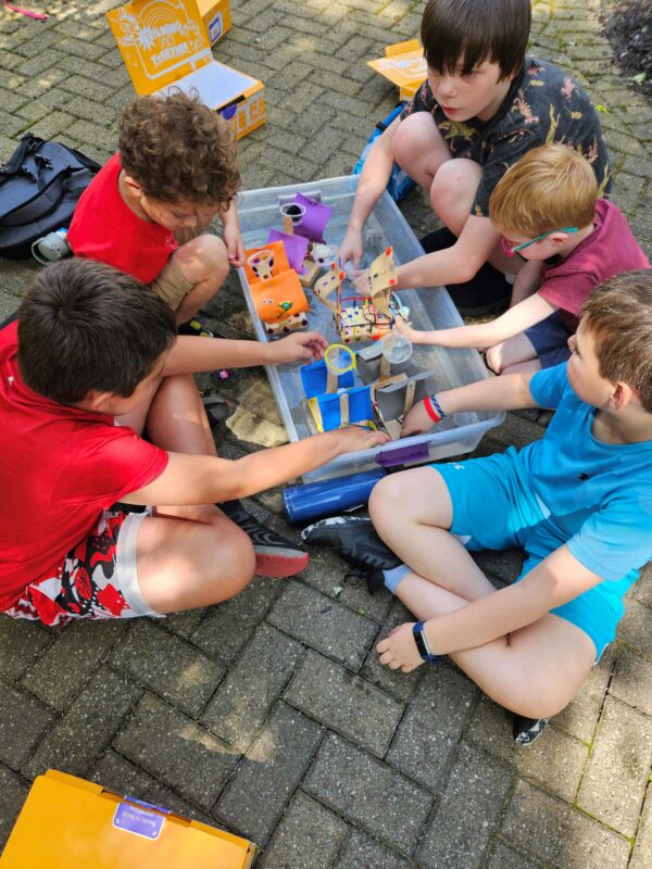 Kids playing outside with boat robot