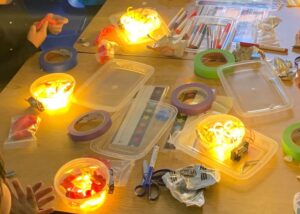 Photograph of table of LED noodle robots and materials