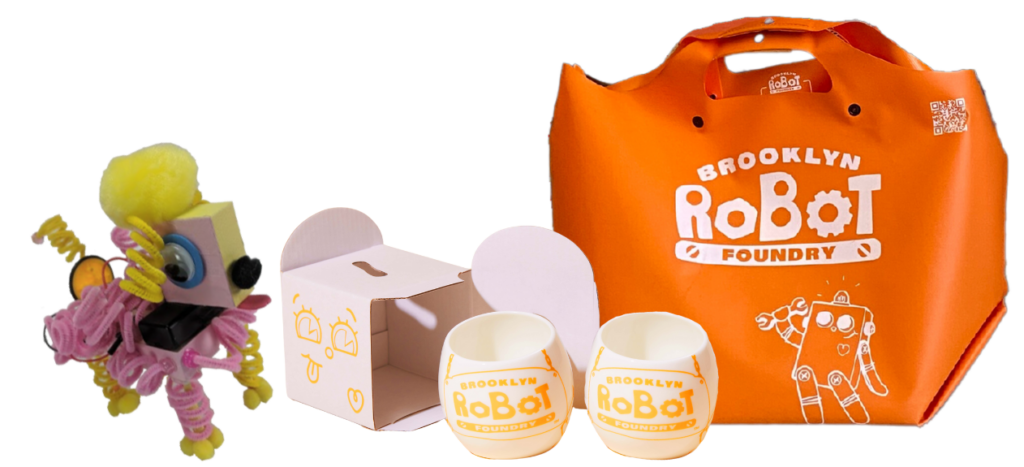 Photo of orange Brooklyn Robot Foundry bag, two mugs and at Pet Puppyborg robot